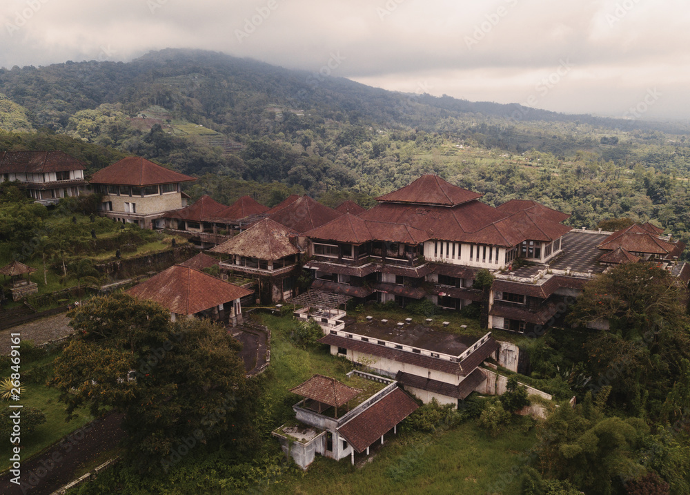 Aerial view of abandoned hotel buildings in tropical mountains