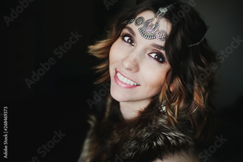 Fototapeta Naklejka Na Ścianę i Meble -  Close up portrait tribal style of beautiful woman wearing jewellery and fur