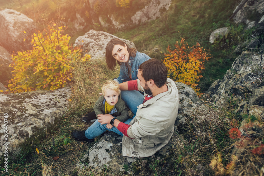 Young family with little son spending time together outside. Young family with little son spending time together outside.