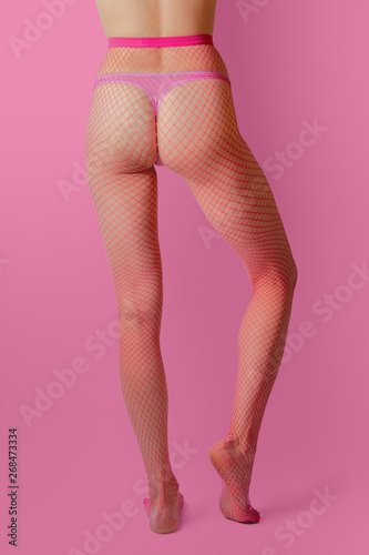Female legs in red fishnet tights