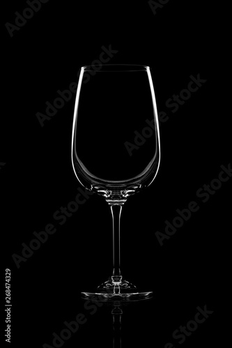 Empty clear wine glass over black background