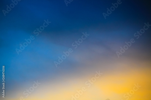 blue yellow gradient of dawn sky. Dusk Time. Vivid twilight evening. Smooth, clear and soft natural background.