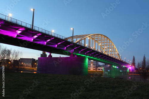 John Frost Bridge in Arnhem during blue hour while colorful lights shine on the bridge