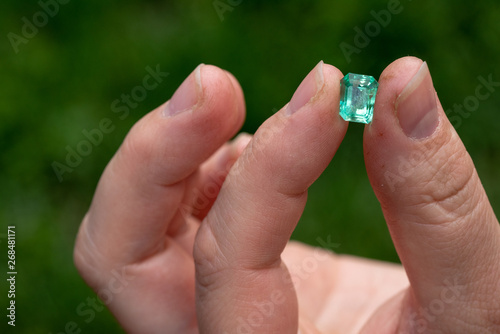 Green Emerald Holding in Hand