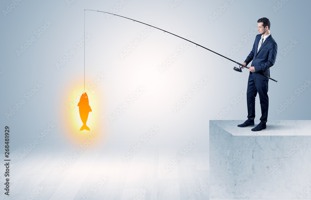 Young businessman fishing golden fish from the top of a building
Young businessman fishing golden fish from the top of a building