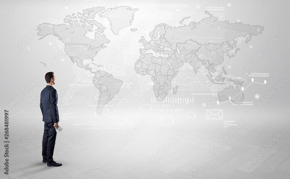 Businessman standing with his back and looking at a worldwide map with objects in his hand
Businessman standing with his back and looking at a worldwide map with objects in his hand