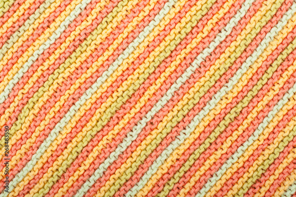 Sweater or scarf fabric texture large knitting. Knitted jersey background with a relief pattern. Wool hand- machine, handmade.