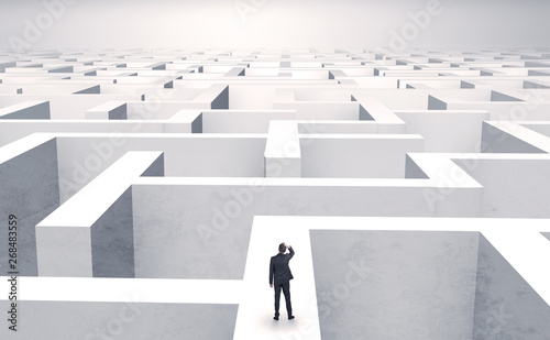 Small businessman in a middle of a huge maze
