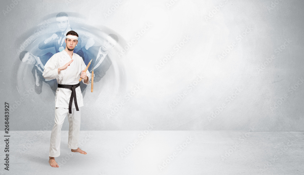 Young businessman in suit fighting with empty wall background
Young businessman in suit fighting with empty wall background