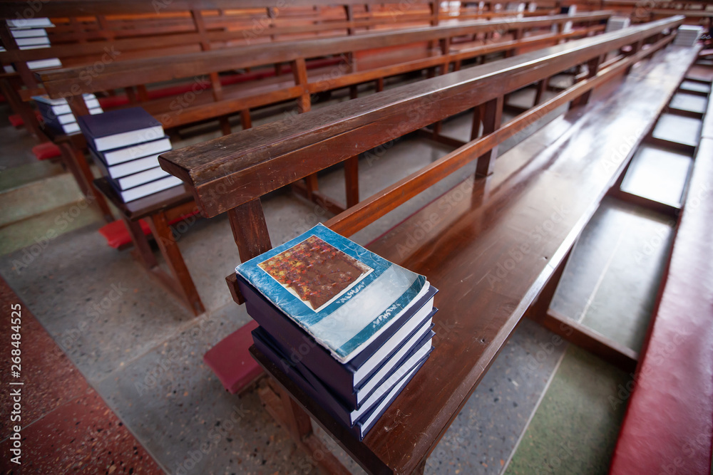 Catholic Prayer Book lay on the rows of wooden church bench.