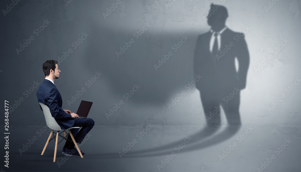 Humble businessman staying and offering stuffs to a huge angry bull shadow
Humble businessman staying and offering stuffs to a huge angry bull shadow