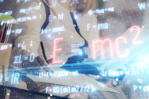 Science formula hologram over woman's hands taking notes background. Concept of study. Multi exposure