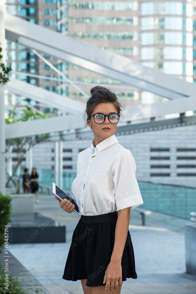 Woman wearing smart casual clothing is using tablet pc Woman wearing smart casual clothing is using tablet pc