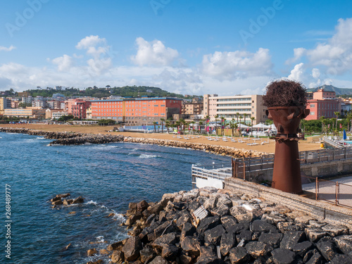 Naples, Campania, Italy: panorama of the beach of Bagnoli with an artistic steel installation, an area reclaimed from the remains of former Italsider steelworks