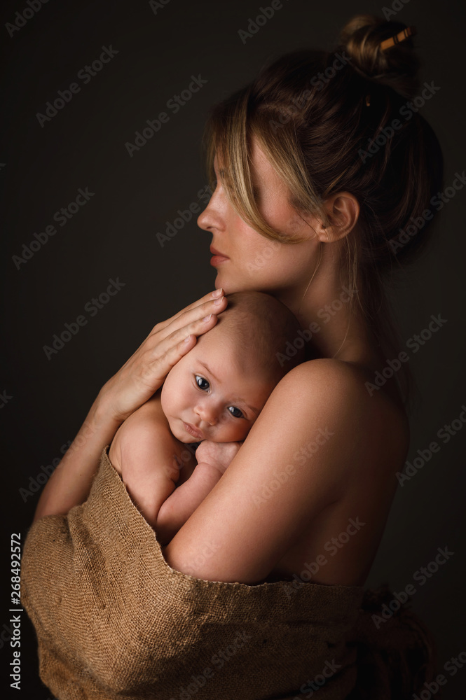 Beautiful mother and her little baby are wrapped in sackcloth Beautiful mother and her little baby are wrapped in sackcloth