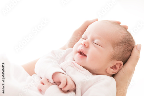 Newborn Baby Sleep on Mother Hands, New Born Girl Smiling and Sleeping, Happy Two Weeks Old Child on White photo
