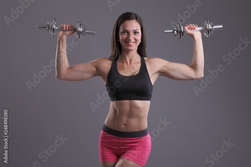 fitness woman in doing exercises with dumbells.