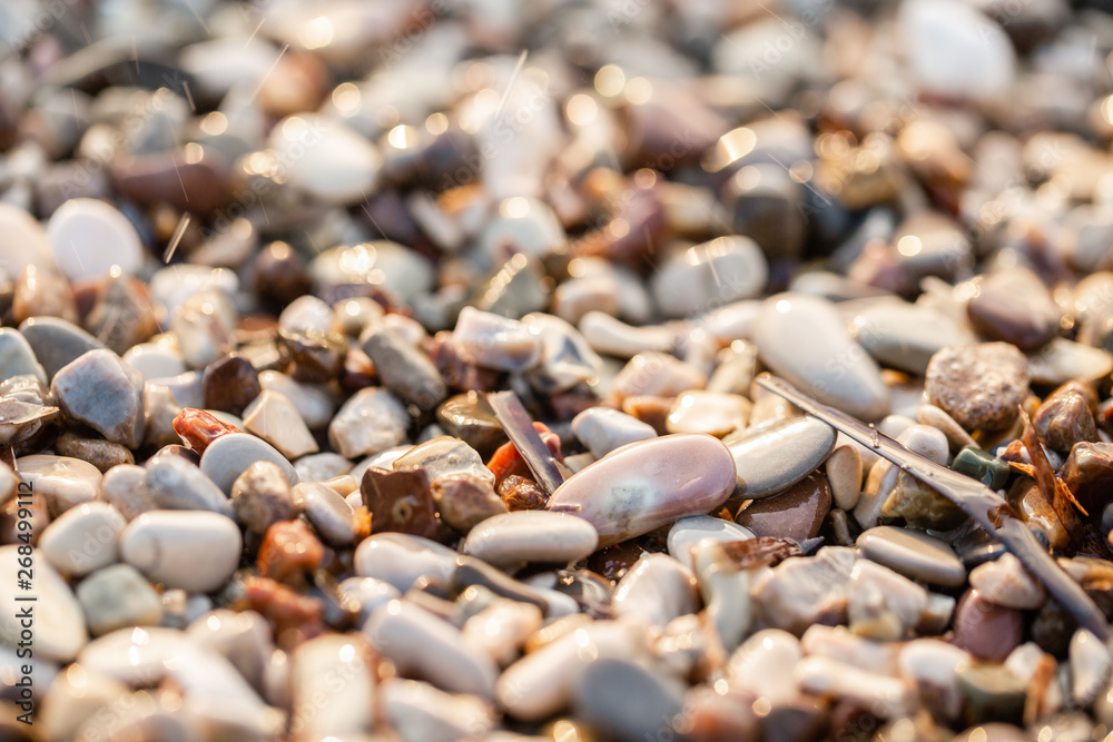 Close up beach stones on the seashore. Summer sunrise on coast, Corfu island, Greece. Beach Ionian sea. Wallpaper Close up beach stones on the seashore. Summer sunrise on coast, Corfu island, Greece. Beach Ionian sea. Wallpaper