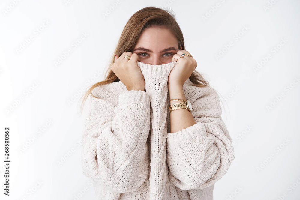 Enthusiastic charismatic good-looking girlfriend playing boyfriend hiding face sweater collar pulling cloth nose smiling eyes giggling having fun, warming up cozy outfit standing white background Enthusiastic charismatic good-looking girlfriend playing boyfriend hiding face sweater collar pulling cloth nose smiling eyes giggling having fun, warming up cozy outfit standing white background