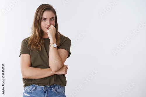 Devious creative intrigued charming european woman have plan thinking biting finger looking mysterious thoughtful, gazing desirable thing, standing curious white background wearing casual clothes