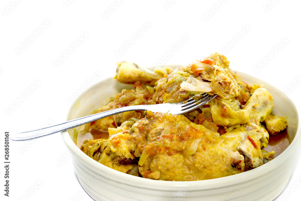 Sliced chicken with sauce in bowl on white background Sliced chicken with sauce in bowl on white background
