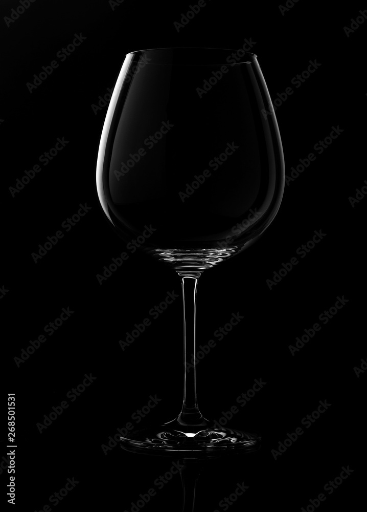 empty wine glass isolated on a dark background empty wine glass isolated on a dark background