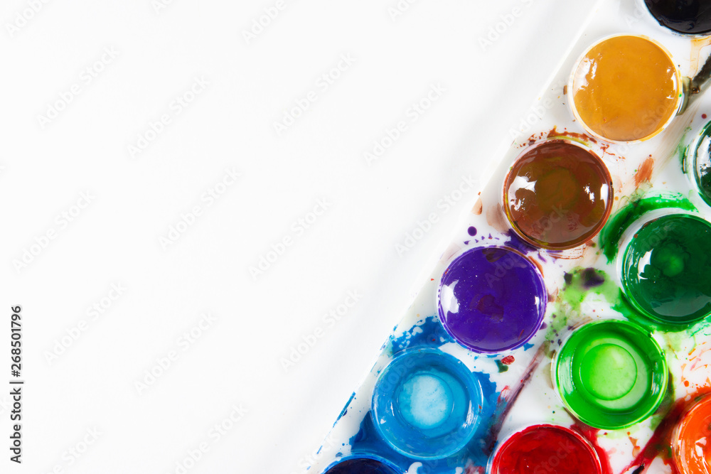 A set of children's paints in circular forms close-up. Copy space for text
