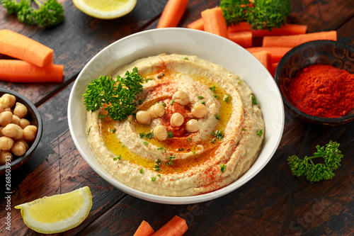 Hummus with olive oil, paprika, lemon and carrot.