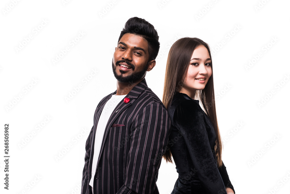 Portrait of a serious young asian couple dressed in formal wear standing back to back over white background Portrait of a serious young asian couple dressed in formal wear standing back to back over white background