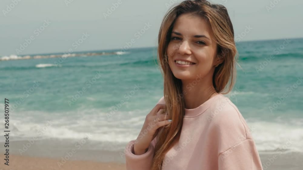 Portrait brunette woman sea, happy student girl smiling cute close up near ocean waves, spain barcelona Portrait brunette woman sea, happy student girl smiling cute close up near ocean waves, spain barcelona