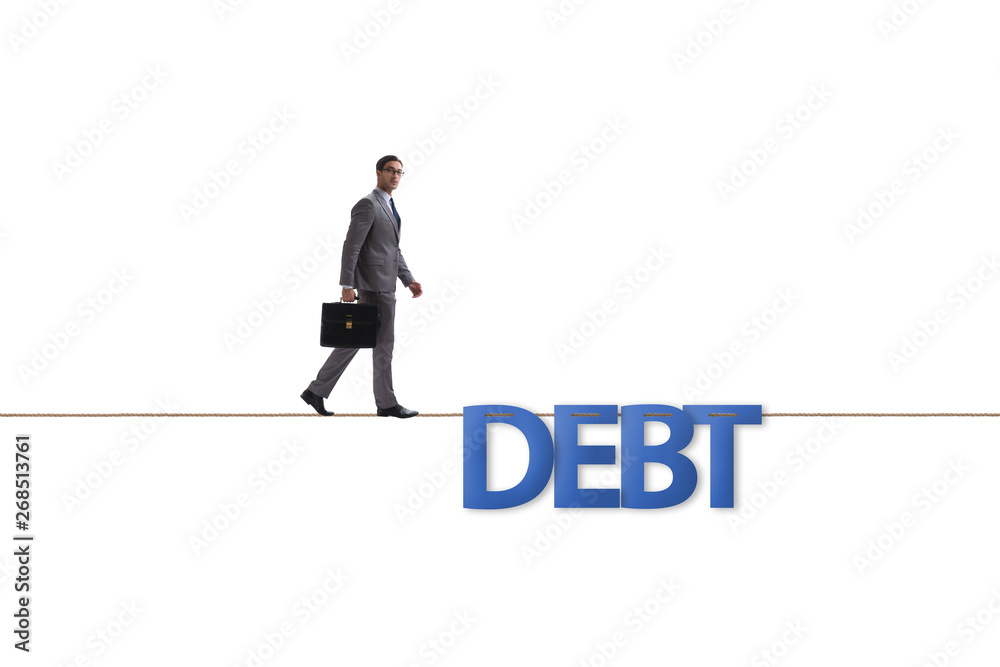 Debt and loan concept with businessman walking on tight rope Debt and loan concept with businessman walking on tight rope