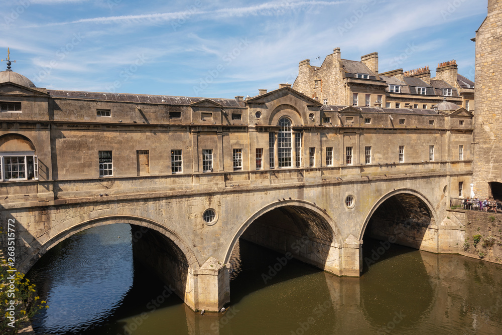 Pulteney Bridge and Weir on the River Avon in the historic city of Bath in Somerset, England .