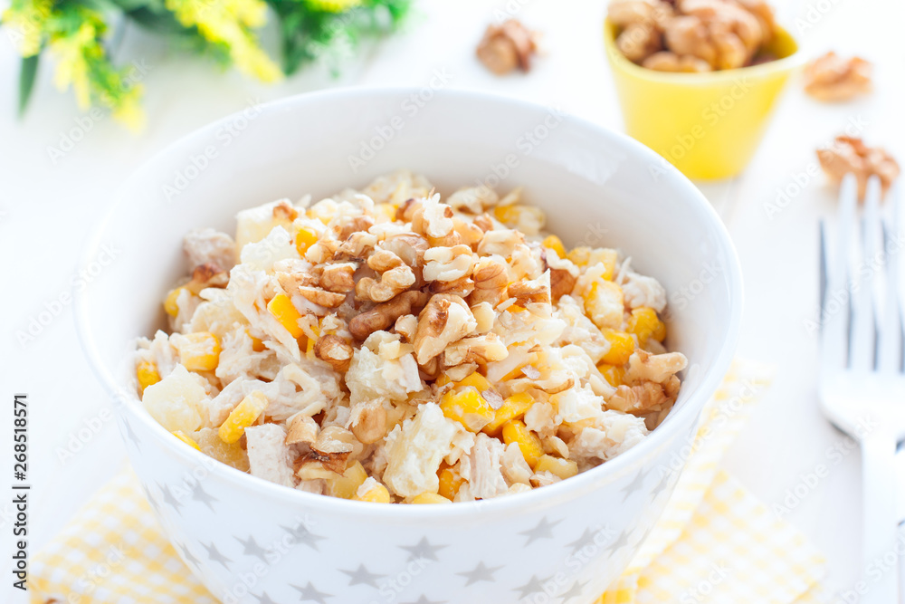 Salad with corn, chicken and pineapples in a white bowl, horizontal Salad with corn, chicken and pineapples in a white bowl, horizontal