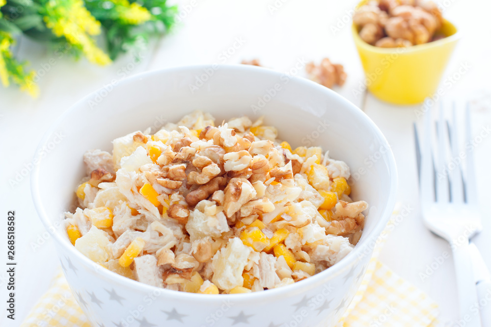 Salad with corn, chicken and pineapples in a white bowl, horizontal Salad with corn, chicken and pineapples in a white bowl, horizontal