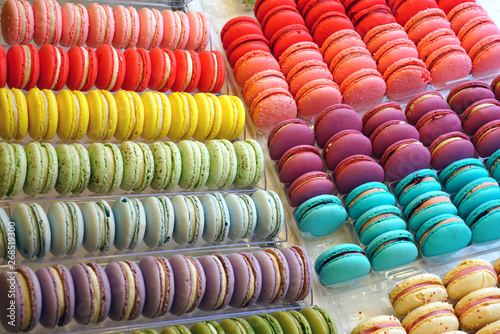 Rows of colorful macaron cookies in a pastry shop
