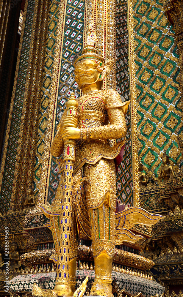 Fototapeta premium Wat Phra Kaew or Temple of Emerald Buddha, Guardian statues and Grand palace located within the grounds of the Grand Palace in Bangkok is Thailand’s most sacred temple and pilgrimage site for Thai