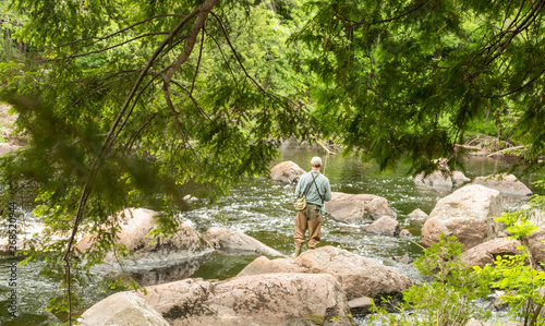 Man fishing in a rocky river © Susan