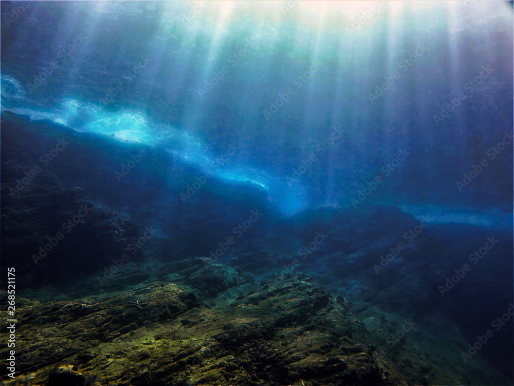 Underwaterphoto of scenery with sunlight and beams underwater