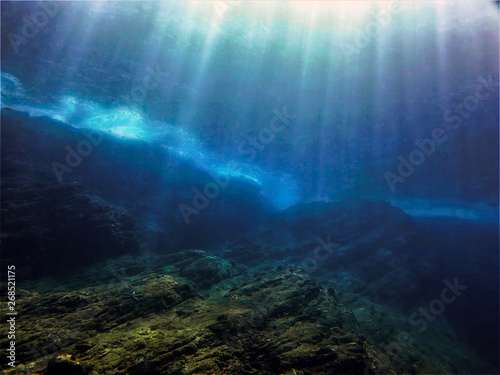 Underwaterphoto of scenery with sunlight and beams underwater