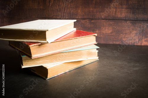 A Stack of old books. Wooden background. Selective focus.