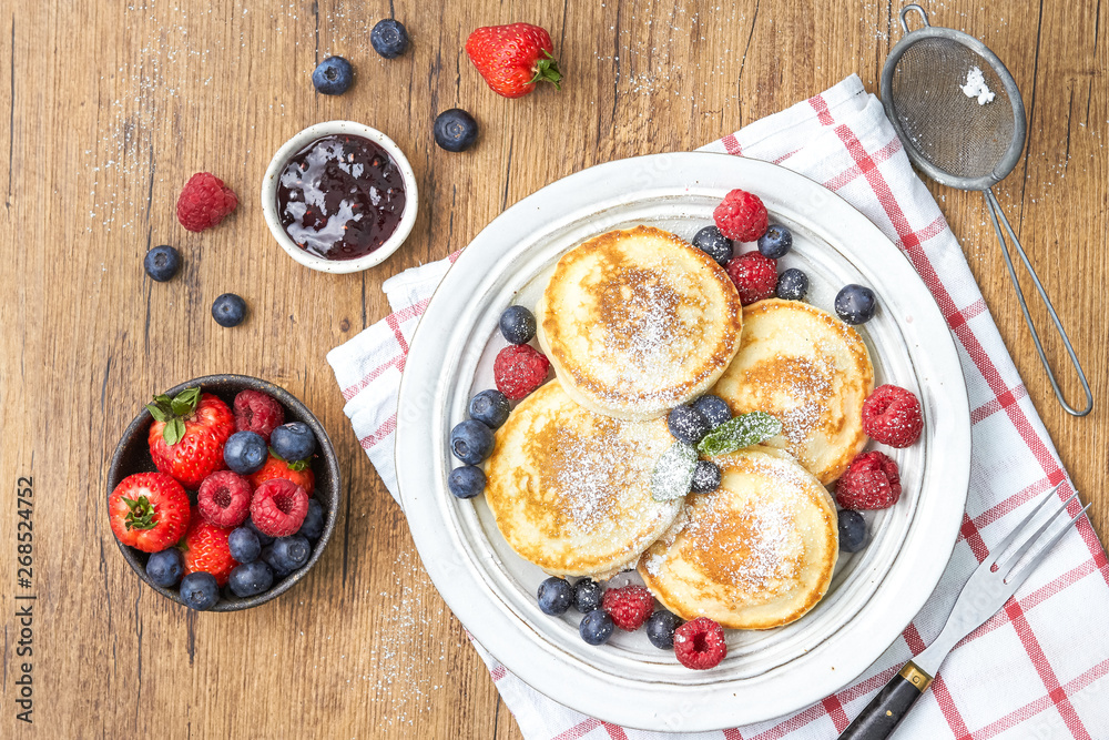Tasty fluffy pancakes with berries Tasty fluffy pancakes with berries