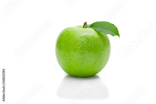Ripe green apple with leaf on a white background .