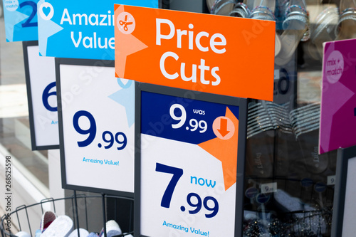 price cuts and amazing value signs outside budget shoe shop photo
