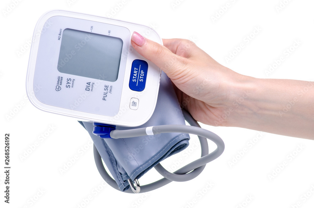 Digital blood pressure monitor electric tonometer in hand on white background isolation Digital blood pressure monitor electric tonometer in hand on white background isolation