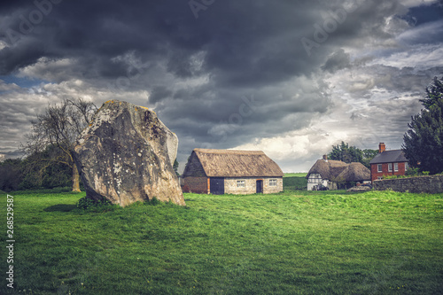 Dramatic clouds and cottage in Avebury Stone Circles, England. photo