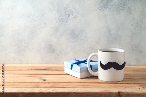Happy Father s day concept with coffee mug and gift box over wooden background