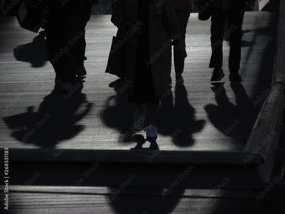 Silhouette of people crossing a bridge Stock Photo | Adobe Stock