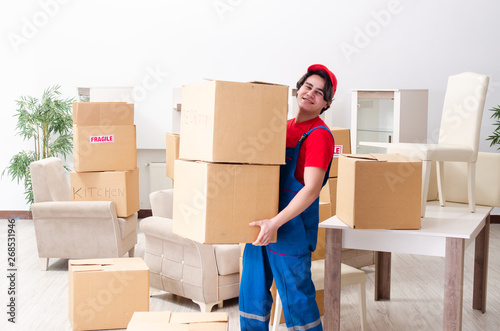 Young male contractor with boxes working indoors  © Elnur