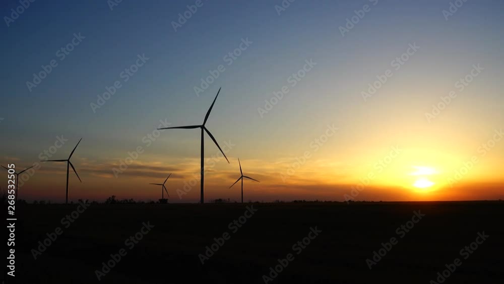 Windmill. Wind farm. Wind turbine. Shooting at a sunset. Windmill. Wind farm. Wind turbine. Shooting at a sunset.