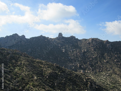 View of Tom's Thumb seen from the trail in the McDowell Sonoran mountain preserve with blue sky in the background